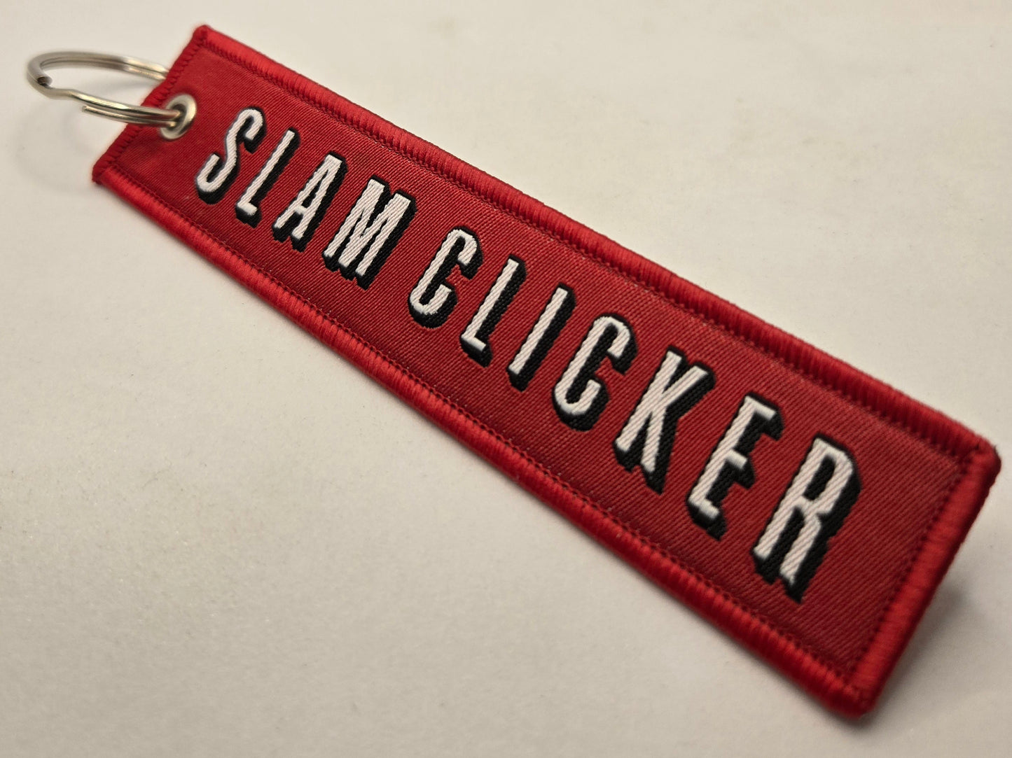 "SLAM CLICKER" bag tag